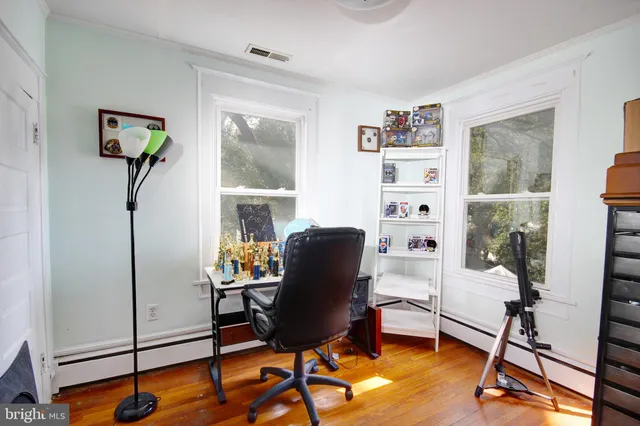 a view of a workspace with furniture and a window