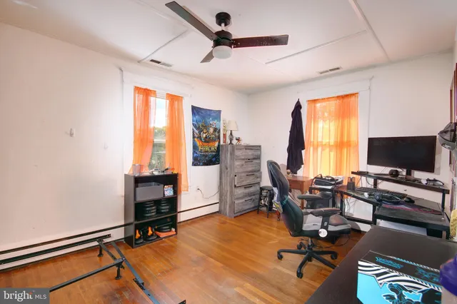 a view of a livingroom with workspace and a window