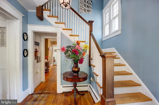 a view of entryway with wooden floor and livingroom