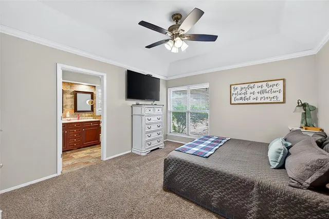 a bedroom with a large bed and a flat screen tv