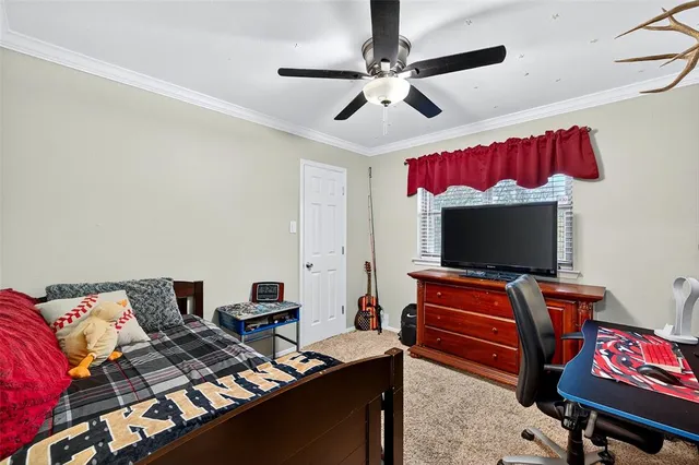 a bedroom with furniture and a flat screen tv