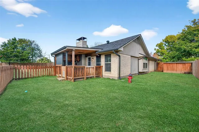 a view of a house with a yard and deck