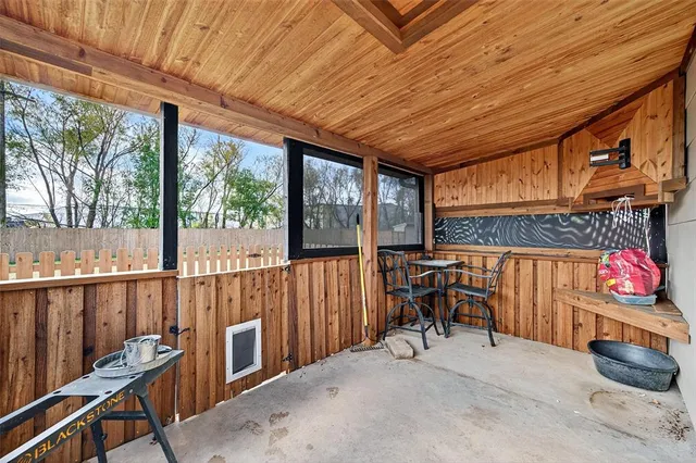 a view of a patio with table and chairs