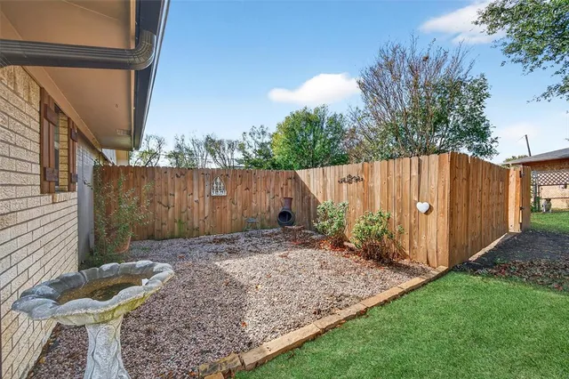 a view of a backyard with potted plants