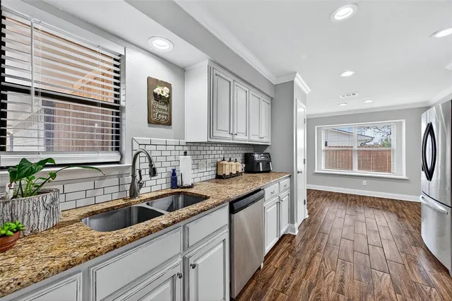 a kitchen with a sink a counter top space and cabinets