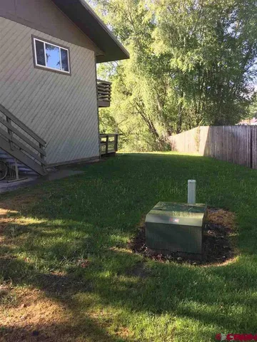 a street view covered with snow in front of house