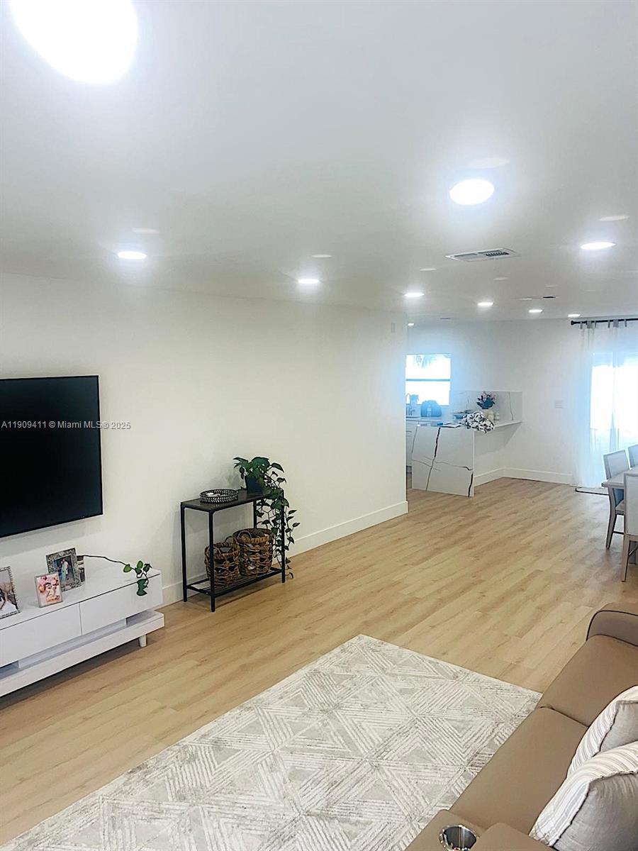 9703 Southwest 2nd Street Boca Raton, FL 33428 - Photo 15 of 17 a spacious bedroom with a bed and a flat screen tv