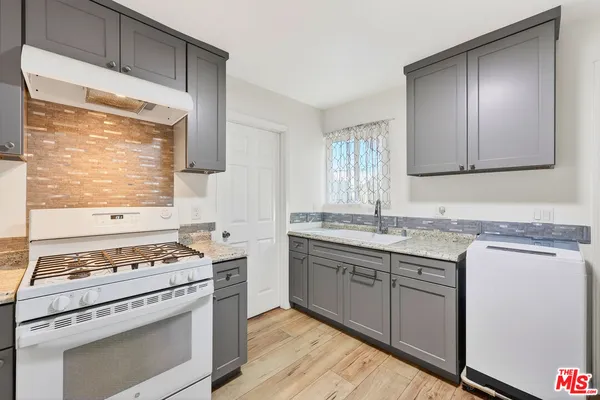 a kitchen with stainless steel appliances granite countertop a stove and a sink