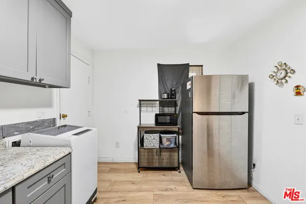 a kitchen with stainless steel appliances granite countertop a refrigerator and a stove