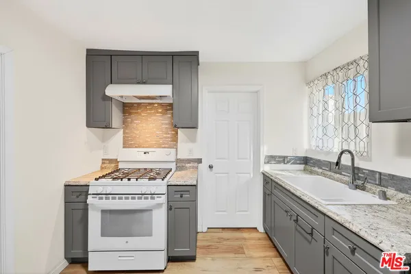 a kitchen with a stove and a sink