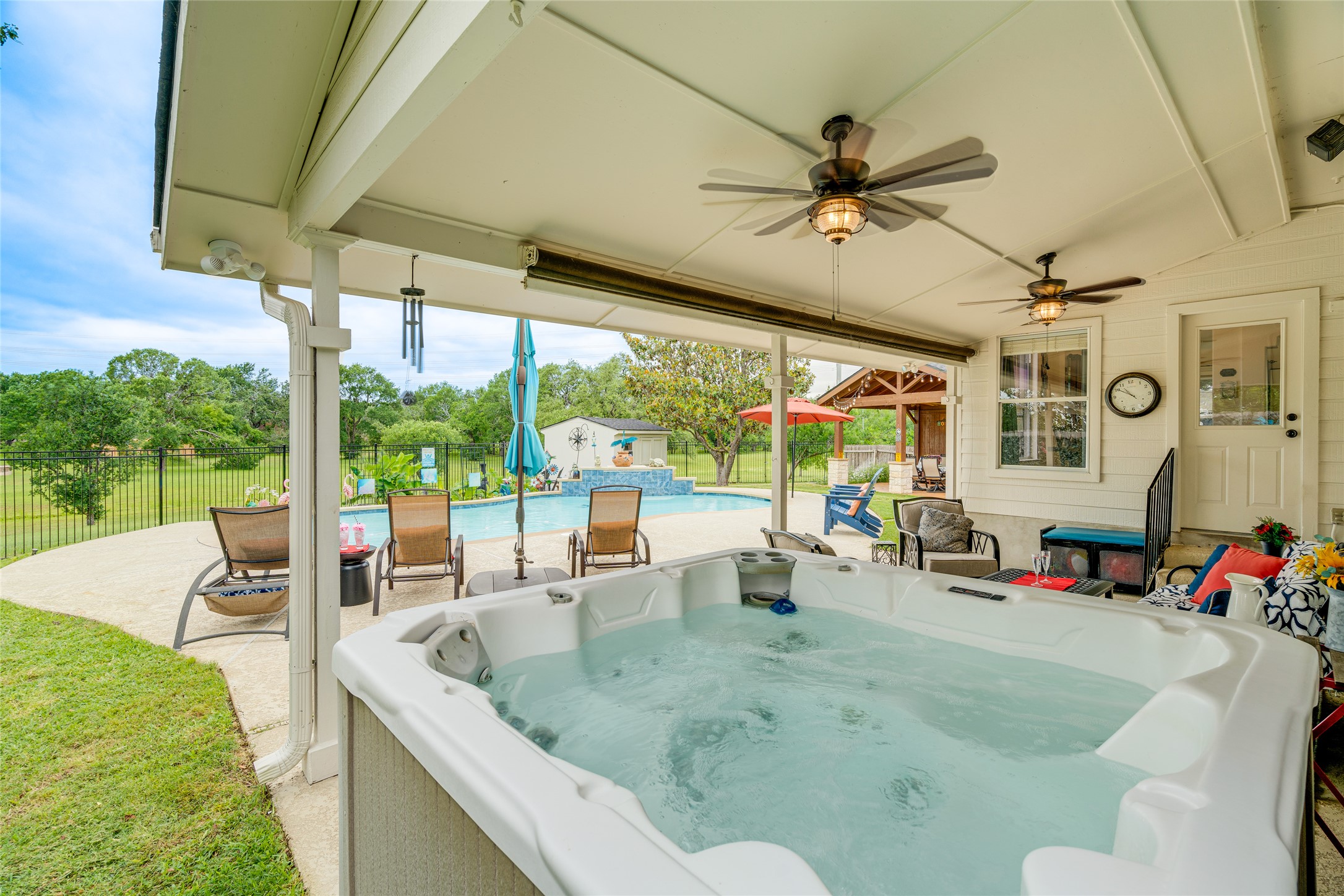 1209 Lacey Oak Loop Round Rock, TX 78681 - Photo 11 of 22 Covered patio with an integrated hot tub and multiple ceiling fans