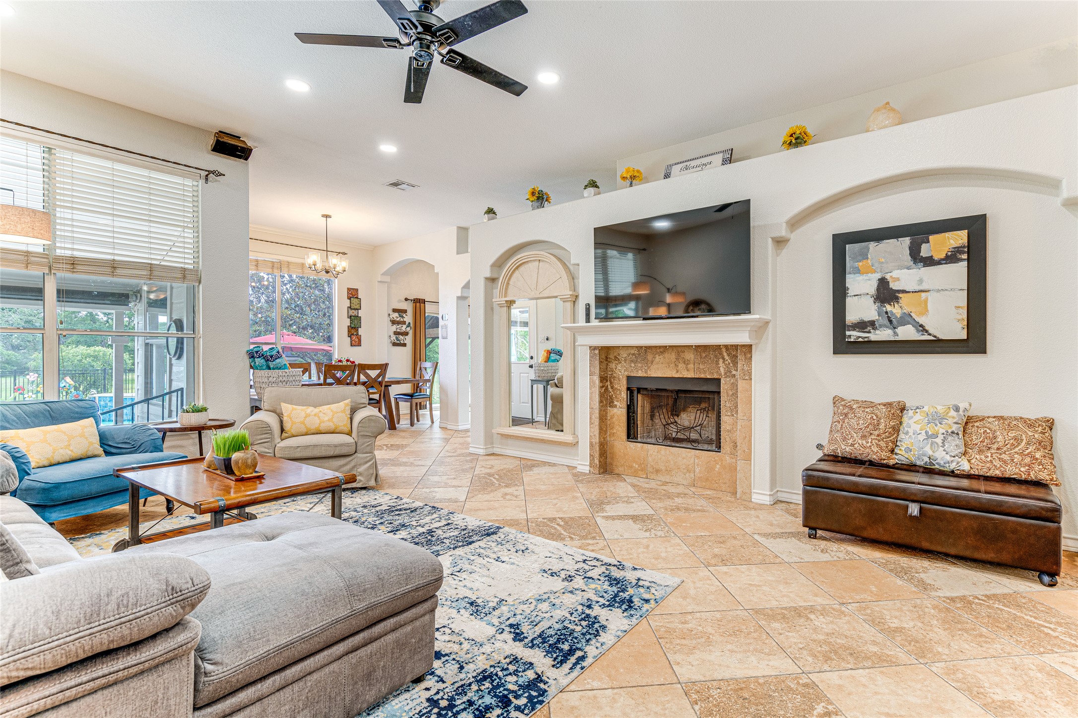 1209 Lacey Oak Loop Round Rock, TX 78681 - Photo 12 of 22 Spacious living area featuring large format tile flooring and a stone-surround fireplace
