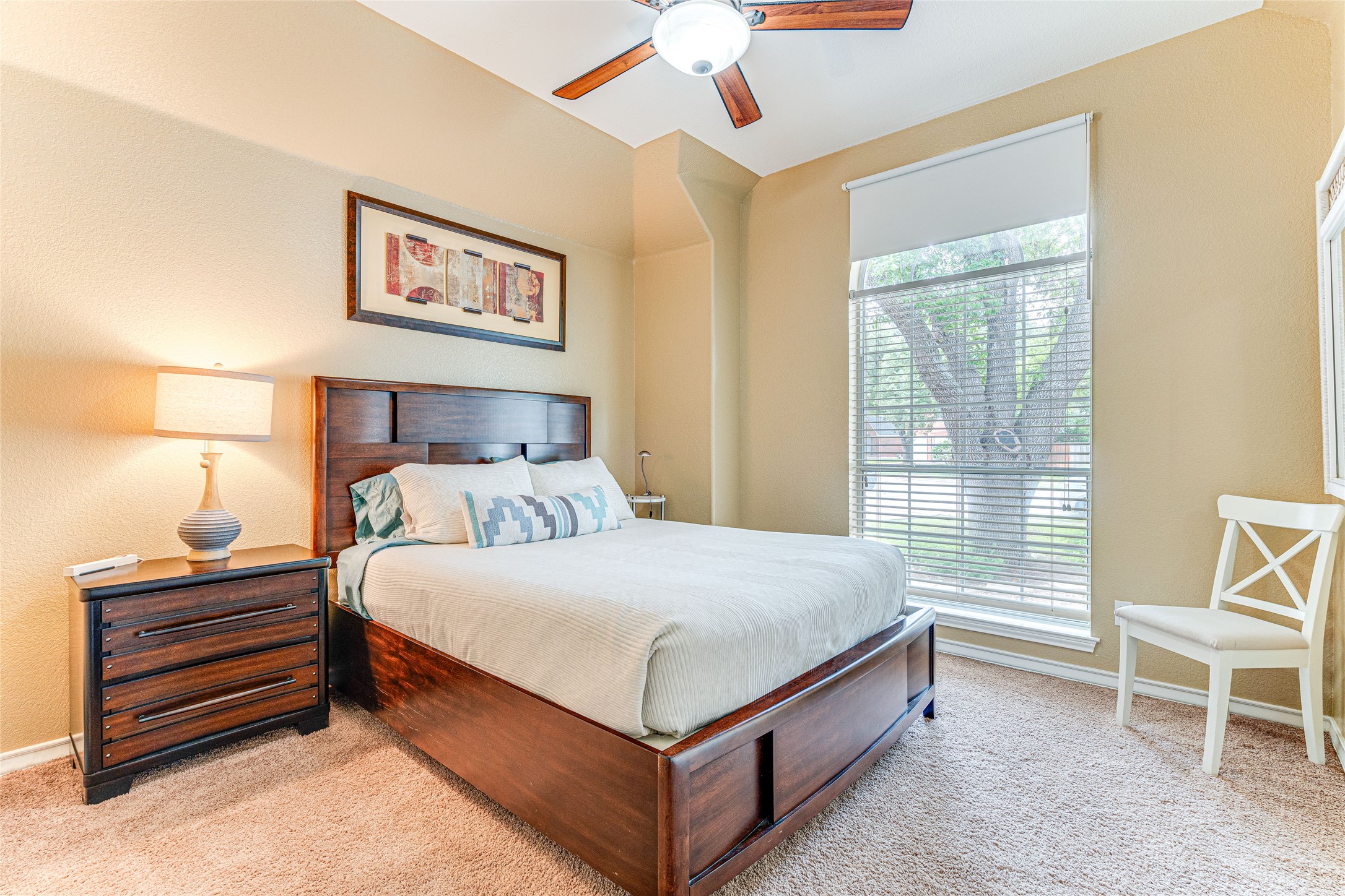 1209 Lacey Oak Loop Round Rock, TX 78681 - Photo 22 of 22 Bedroom featuring high ceilings, a ceiling fan with integrated lighting, textured carpeting, and a large window with blinds and a roller shade