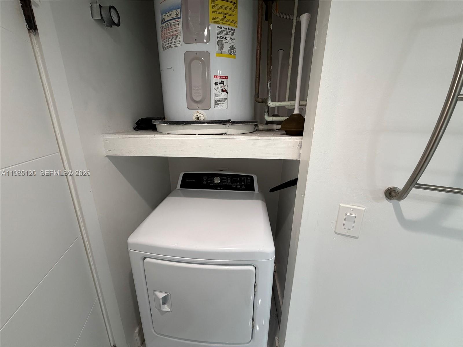 18328 Northwest 68th Avenue, Unit I Hialeah, FL 33015 - Photo 12 of 15 a utility room with dryer and washer
