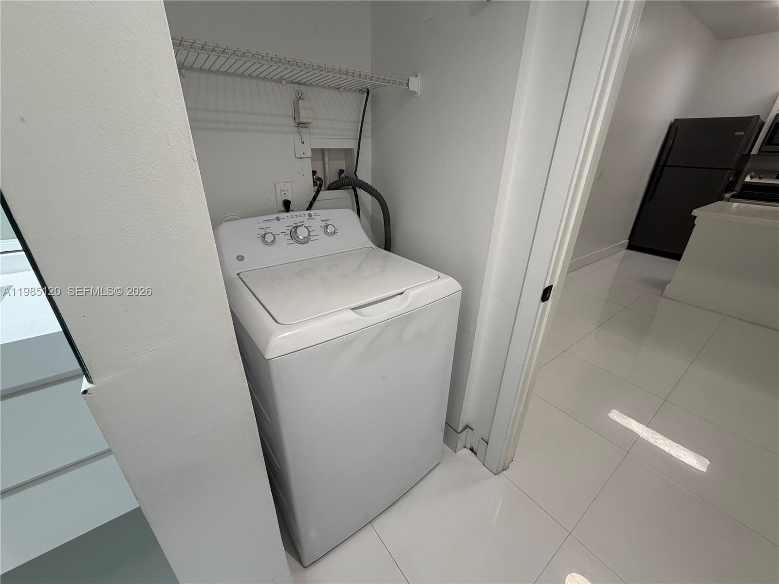 18328 Northwest 68th Avenue, Unit I Hialeah, FL 33015 - Photo 13 of 15 a utility room with dryer and washer