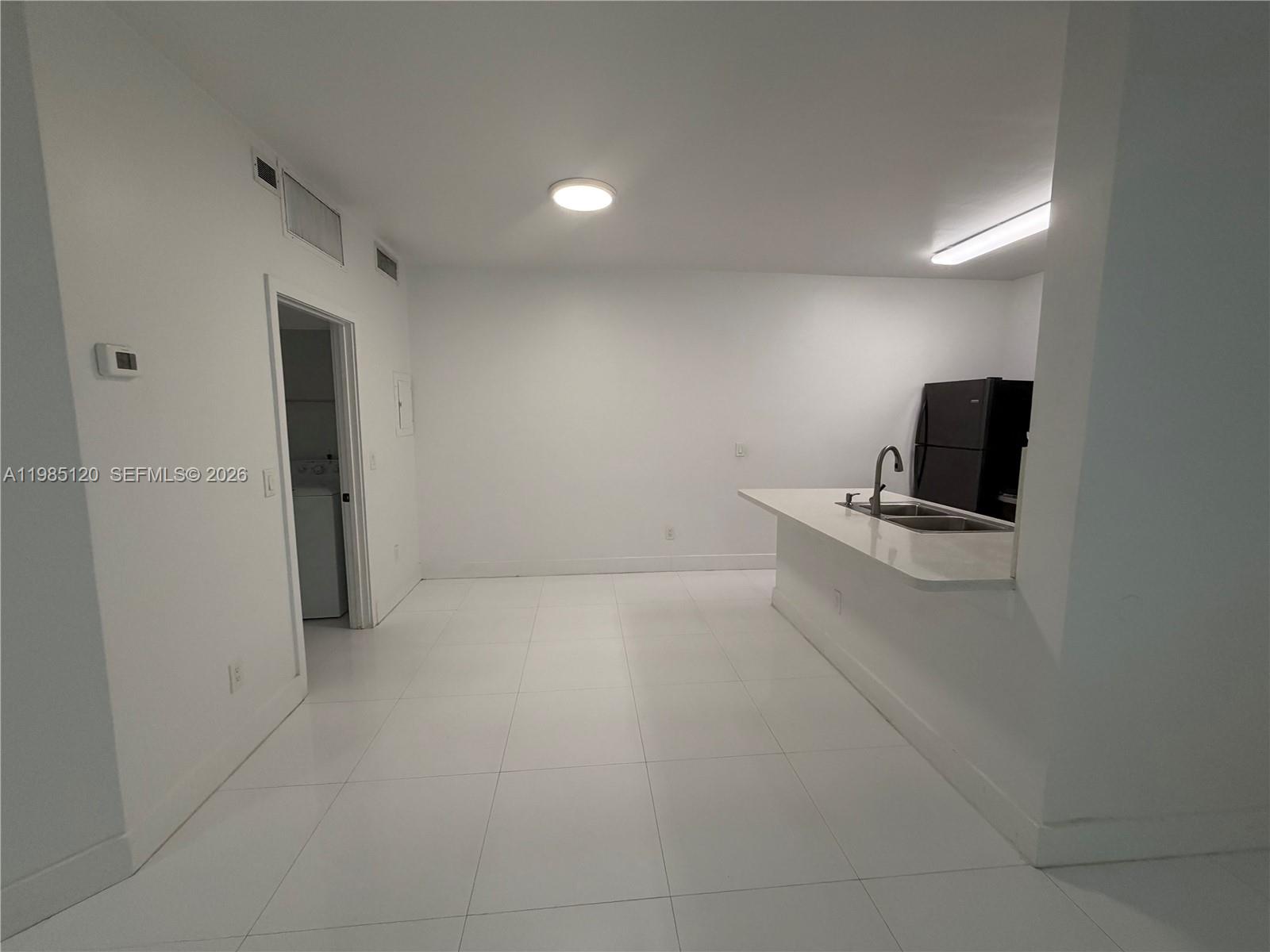 18328 Northwest 68th Avenue, Unit I Hialeah, FL 33015 - Photo 5 of 15 a view of a livingroom with a flat screen tv