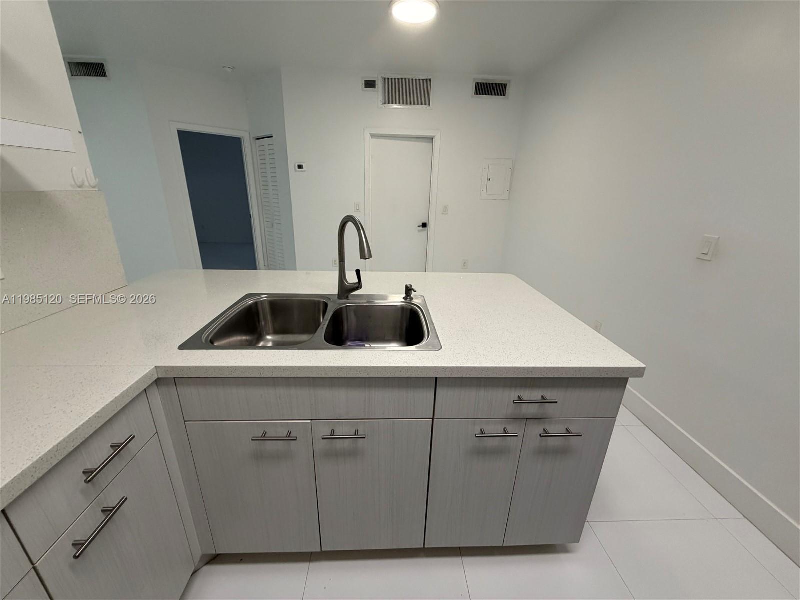 18328 Northwest 68th Avenue, Unit I Hialeah, FL 33015 - Photo 7 of 15 a view with cabinets