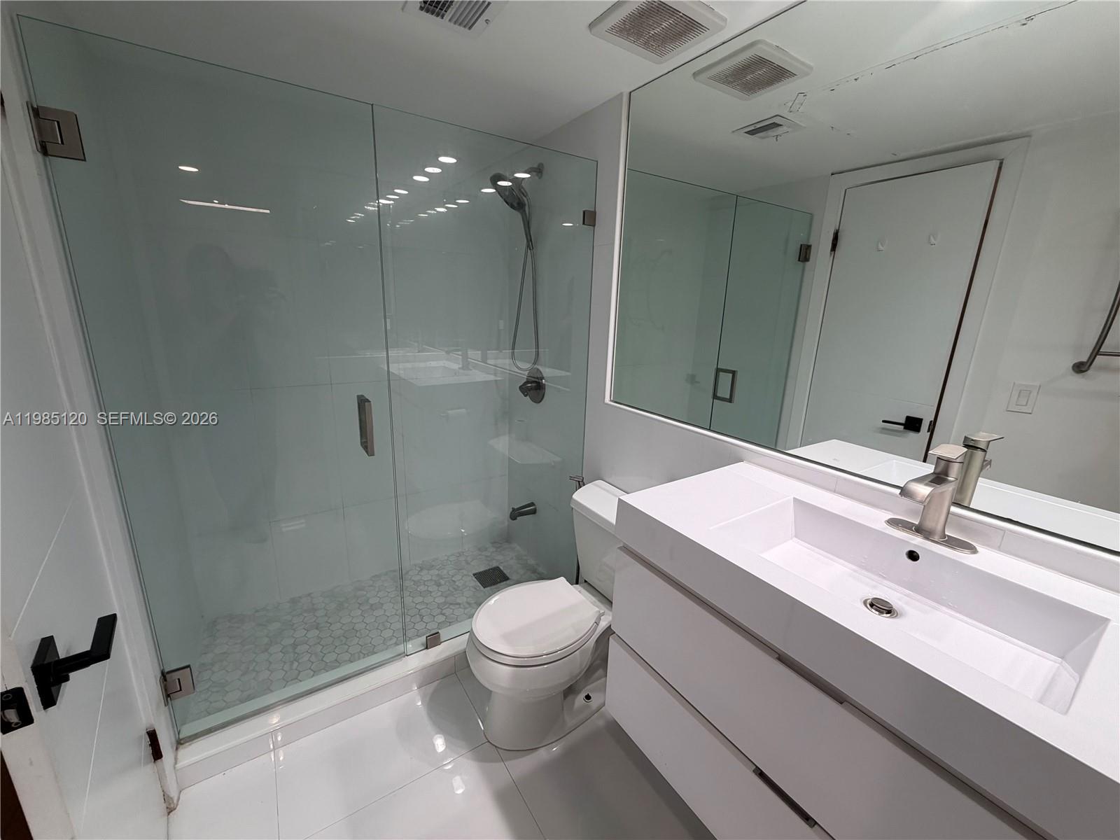 18328 Northwest 68th Avenue, Unit I Hialeah, FL 33015 - Photo 10 of 15 a bathroom with a sink a toilet and shower