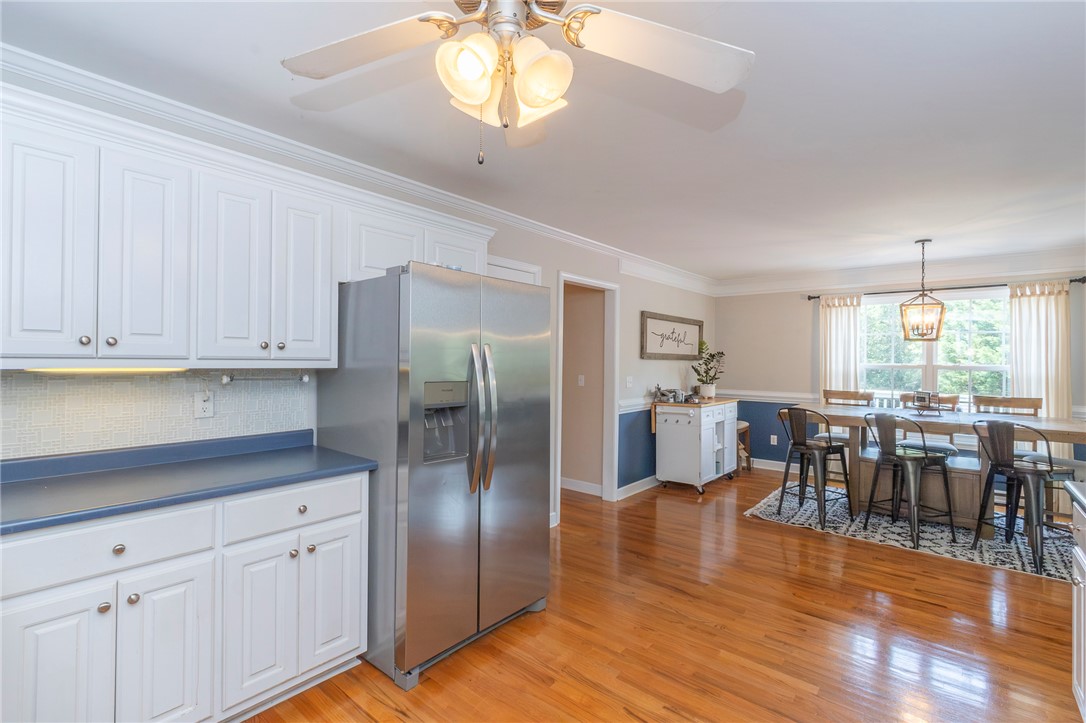 861 North Old Pendleton Road Liberty, SC 29657 - Photo 12 of 45 A vibrant kitchen and dining area, featuring classic hardwood floors and ample natural illumination.