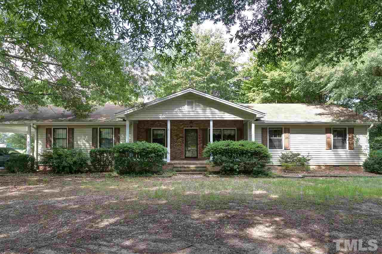 10036 Ten-Ten Road Raleigh, NC 27603 - Photo 1 of 25 a front view of a house with yard and green space