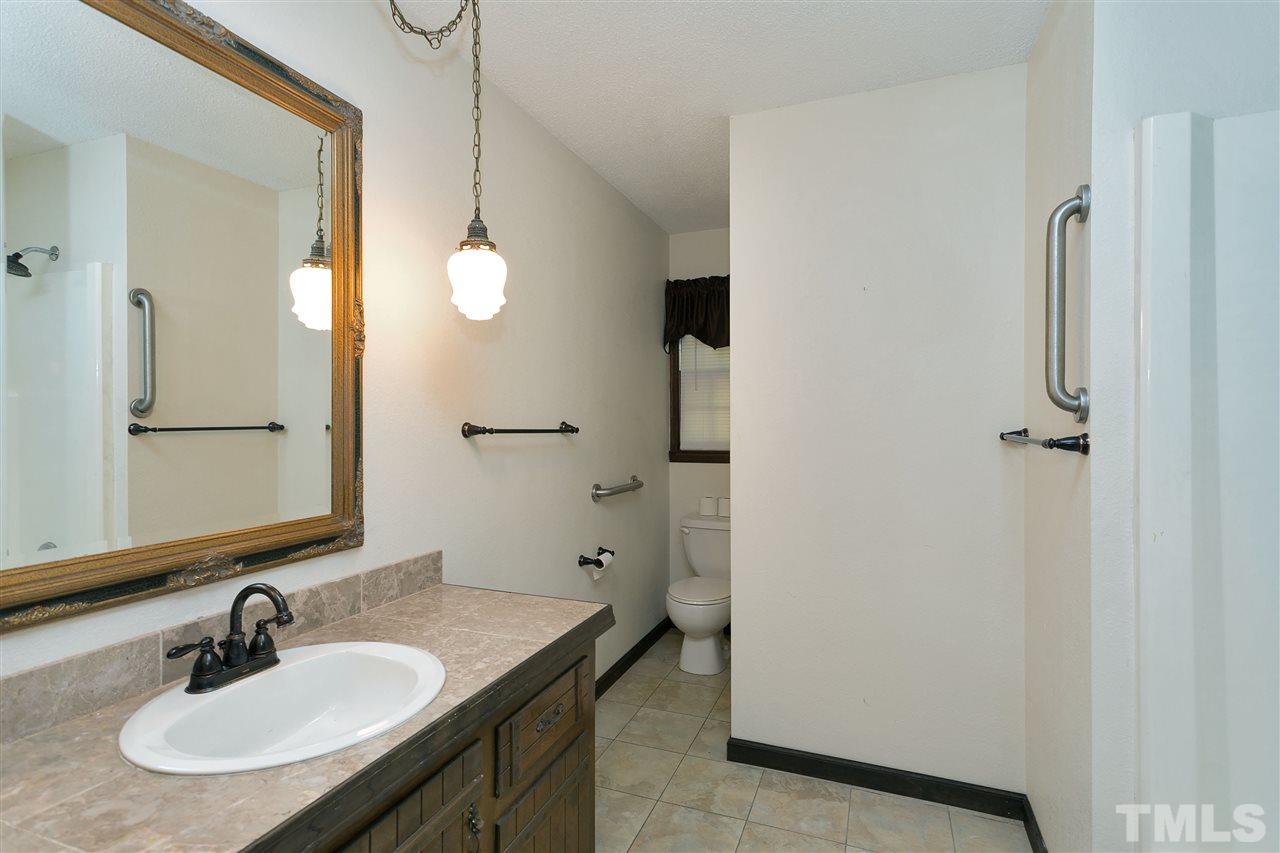 10036 Ten-Ten Road Raleigh, NC 27603 - Photo 13 of 25 a bathroom with a sink and a mirror