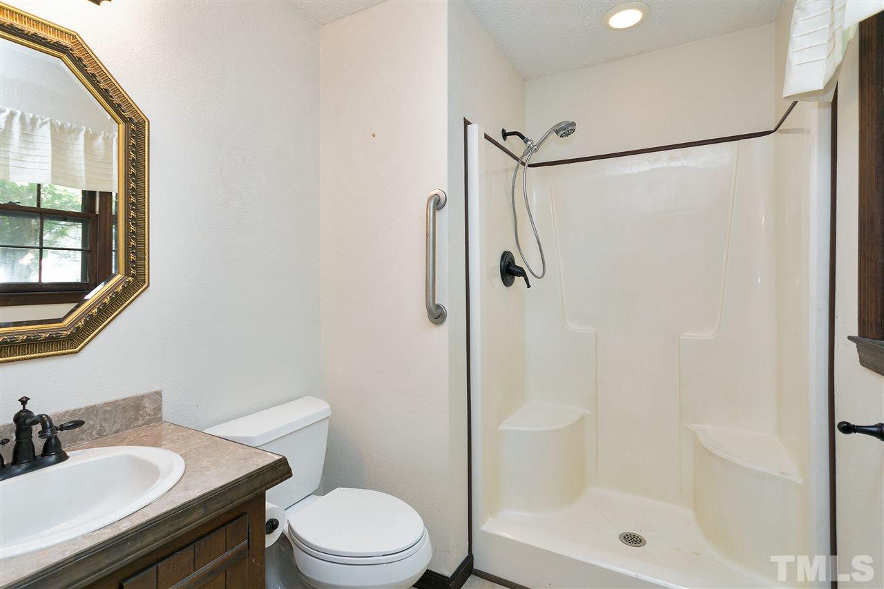 10036 Ten-Ten Road Raleigh, NC 27603 - Photo 16 of 25 a bathroom with a sink toilet and shower