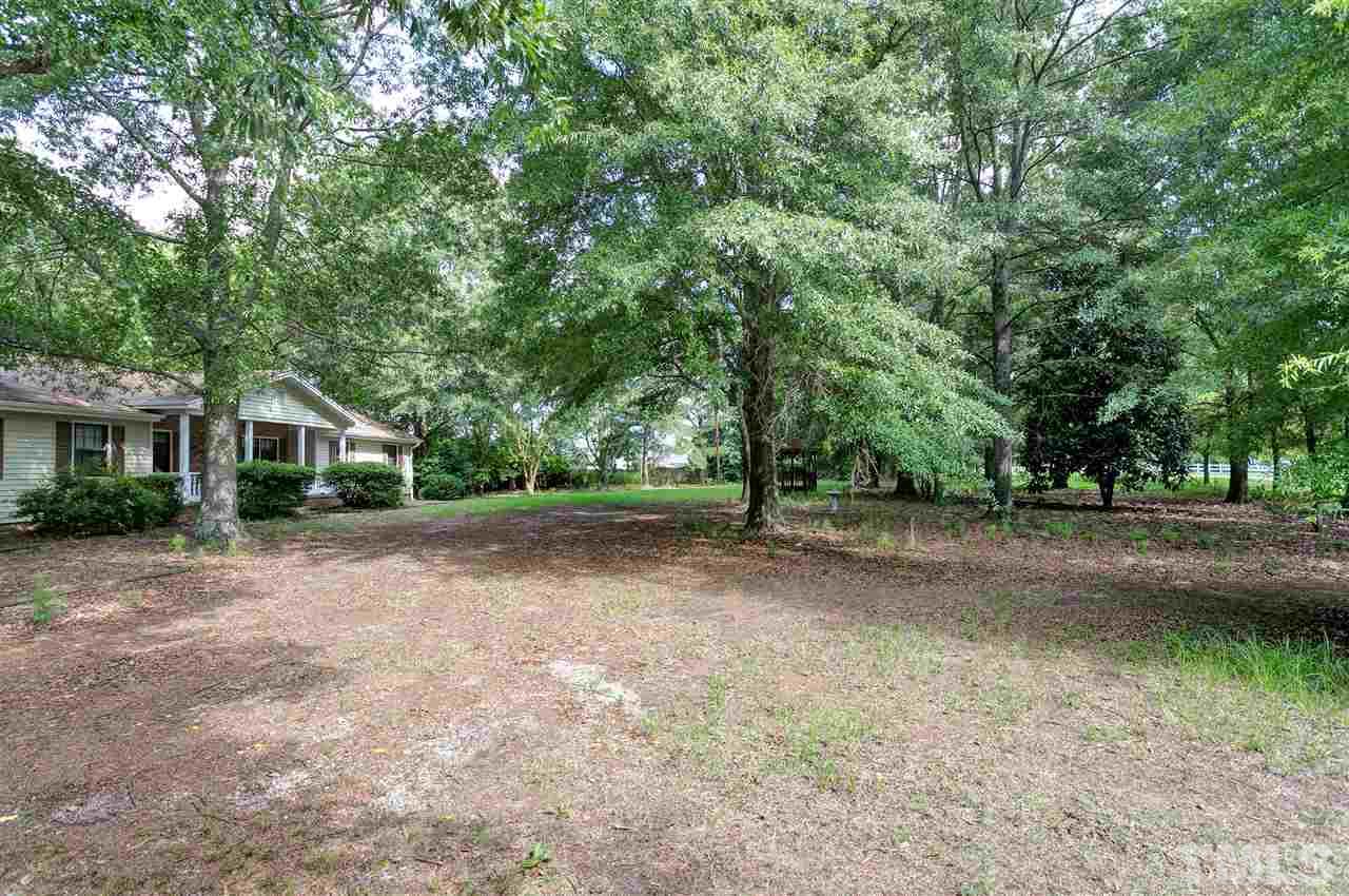 10036 Ten-Ten Road Raleigh, NC 27603 - Photo 21 of 25 a view of a house with a yard