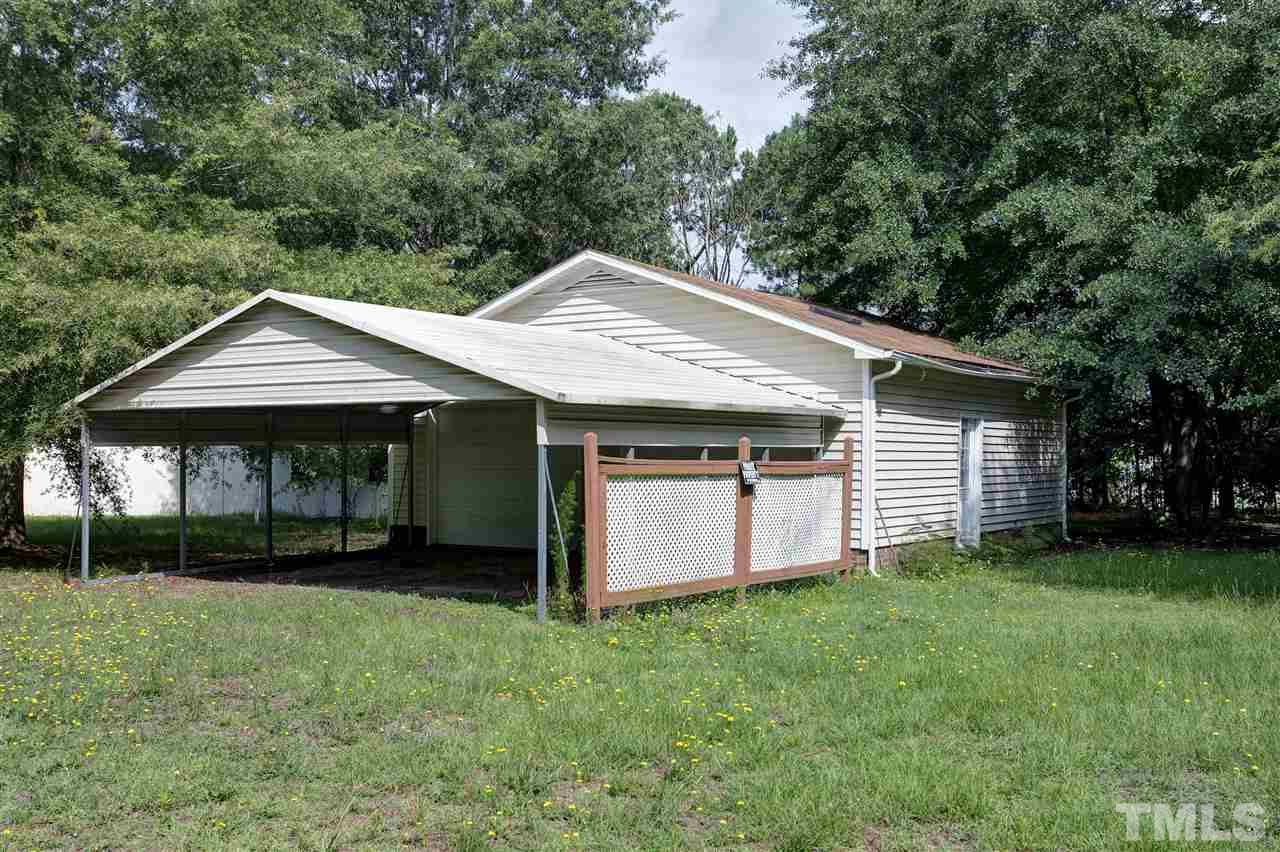 10036 Ten-Ten Road Raleigh, NC 27603 - Photo 23 of 25 a front view of a house with a garden