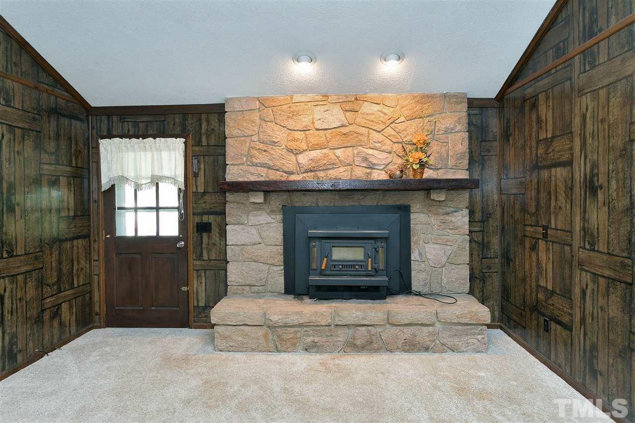 10036 Ten-Ten Road Raleigh, NC 27603 - Photo 4 of 25 a living room with furniture and a fireplace