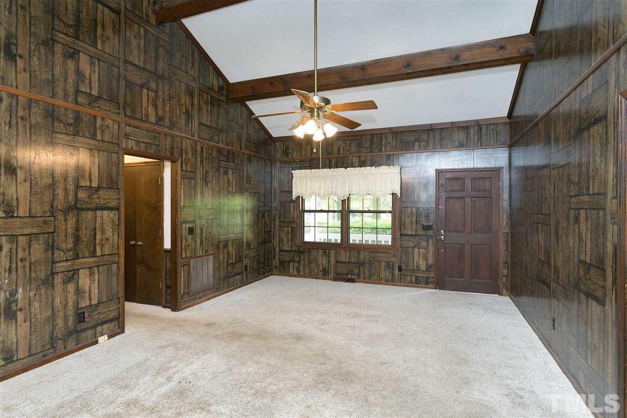 10036 Ten-Ten Road Raleigh, NC 27603 - Photo 5 of 25 a bedroom with a bed and a chandelier