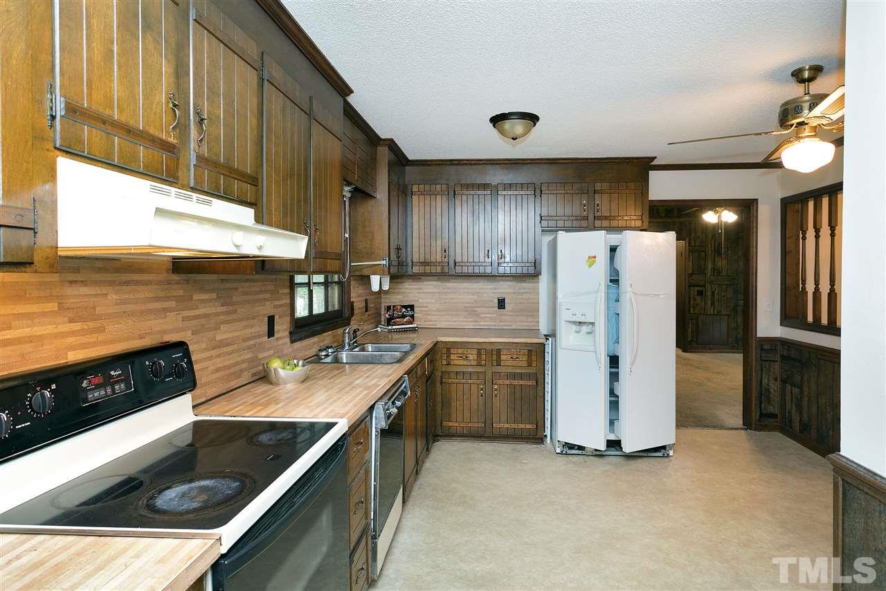 10036 Ten-Ten Road Raleigh, NC 27603 - Photo 10 of 25 a kitchen with refrigerator cabinets and a sink