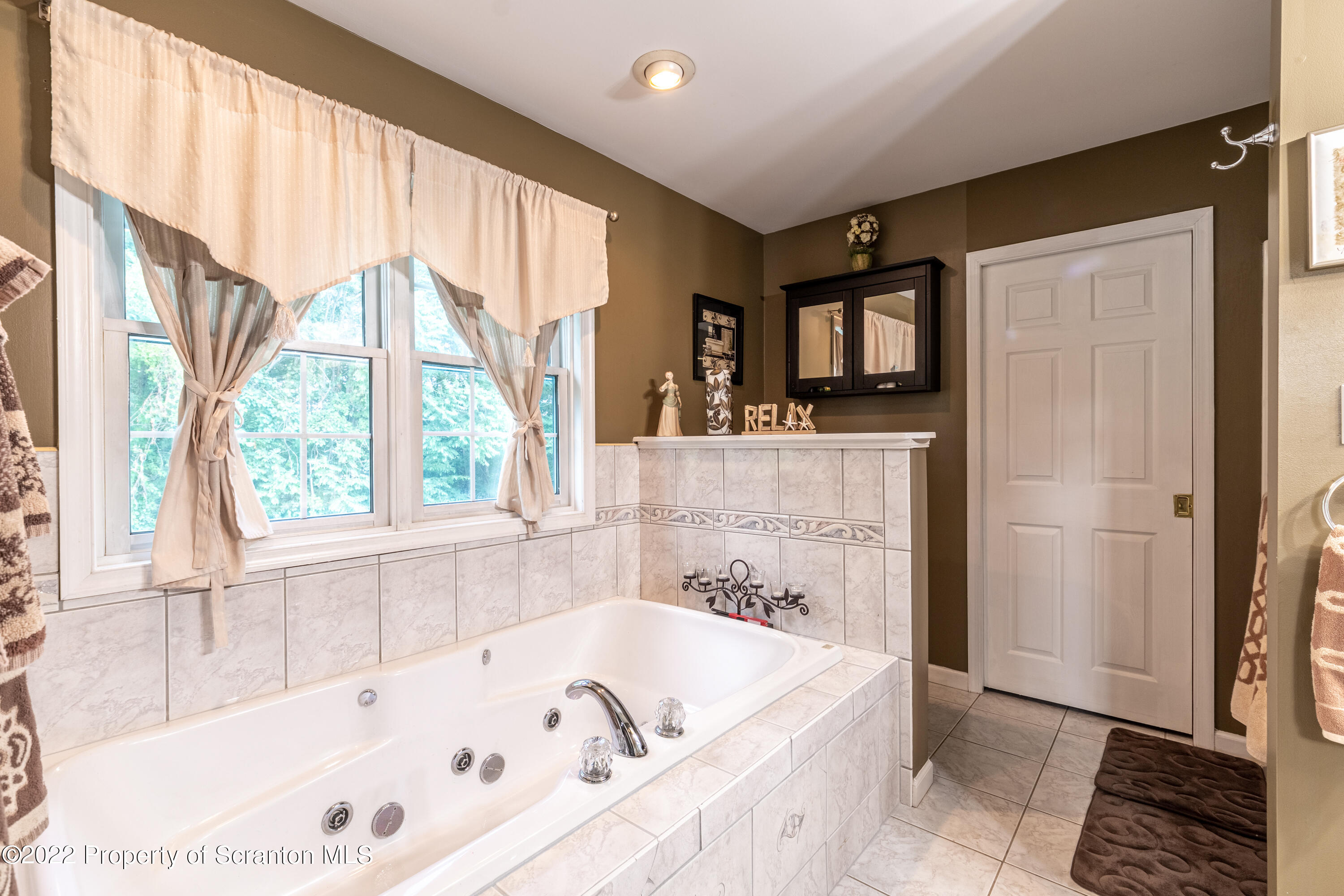 112 Blackberry Lane Duryea, PA 18642 - Photo 20 of 29 a bath tub sitting in a bathroom next to a window