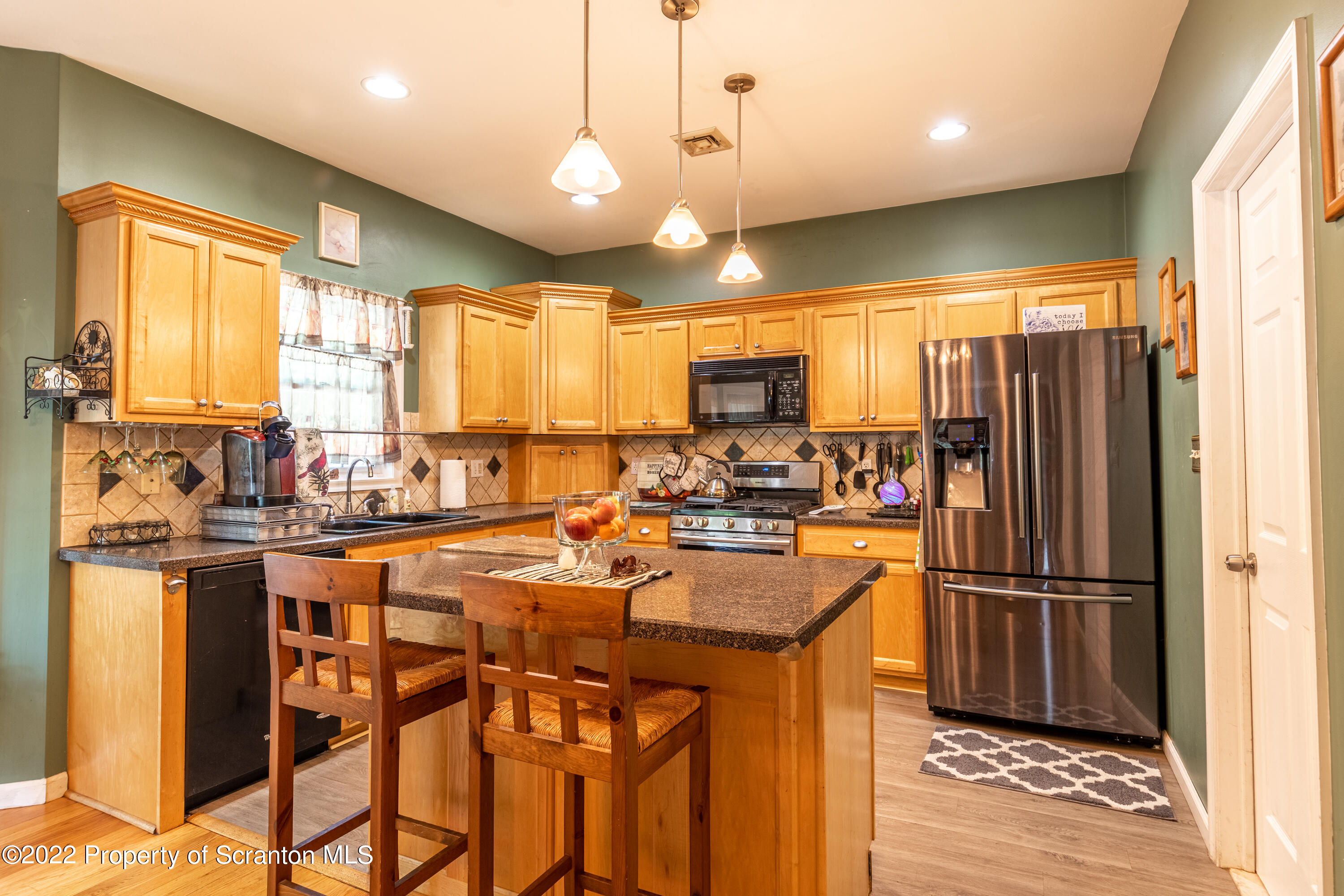 112 Blackberry Lane Duryea, PA 18642 - Photo 7 of 29 a kitchen with stainless steel appliances granite countertop a refrigerator a sink dishwasher a stove and a dining table with wooden floor