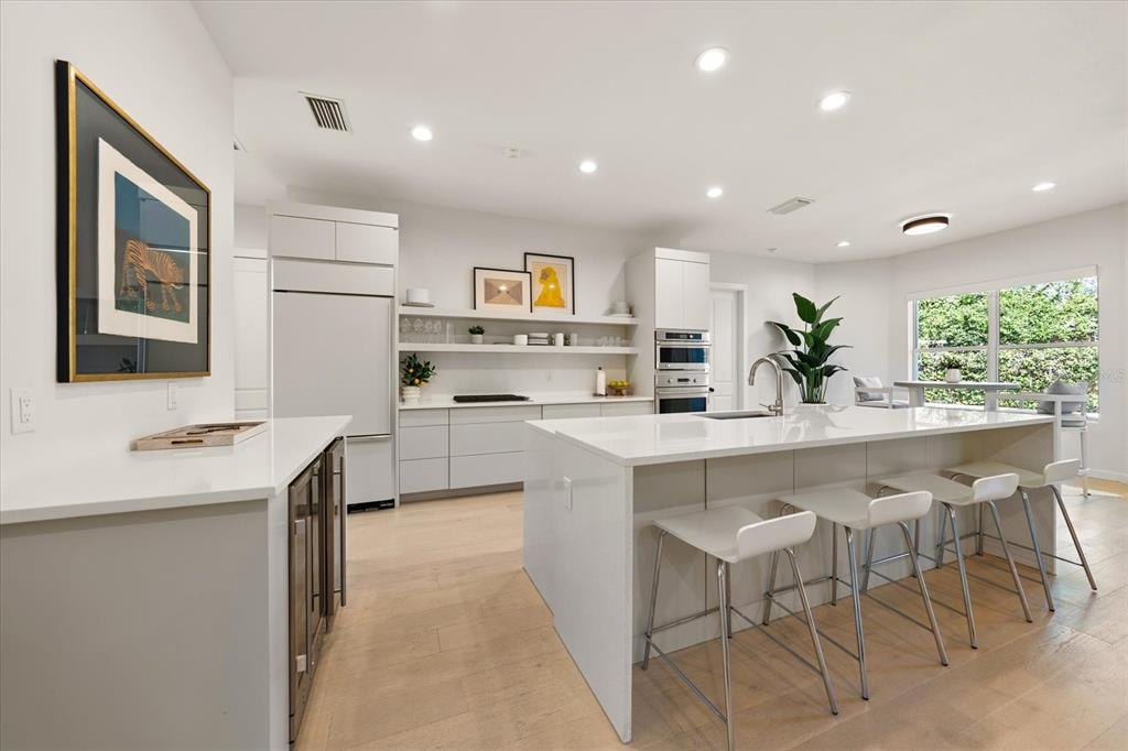 3901 West Granada Street Tampa, FL 33629 - Photo 11 of 45 a kitchen with stainless steel appliances a white table chairs and a refrigerator