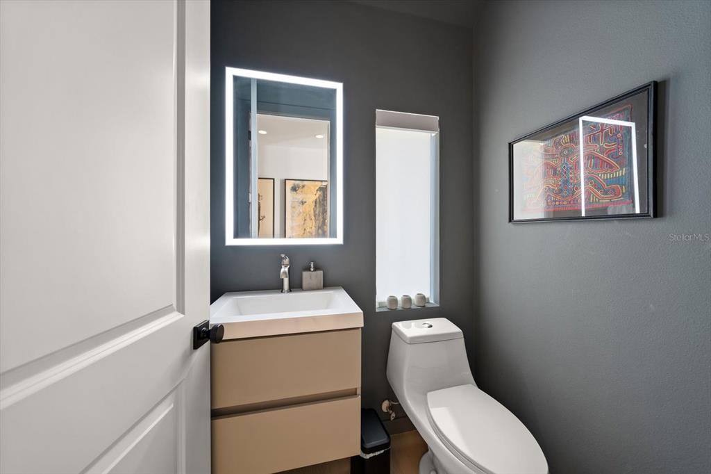 3901 West Granada Street Tampa, FL 33629 - Photo 22 of 45 a bathroom with a toilet sink vanity and mirror