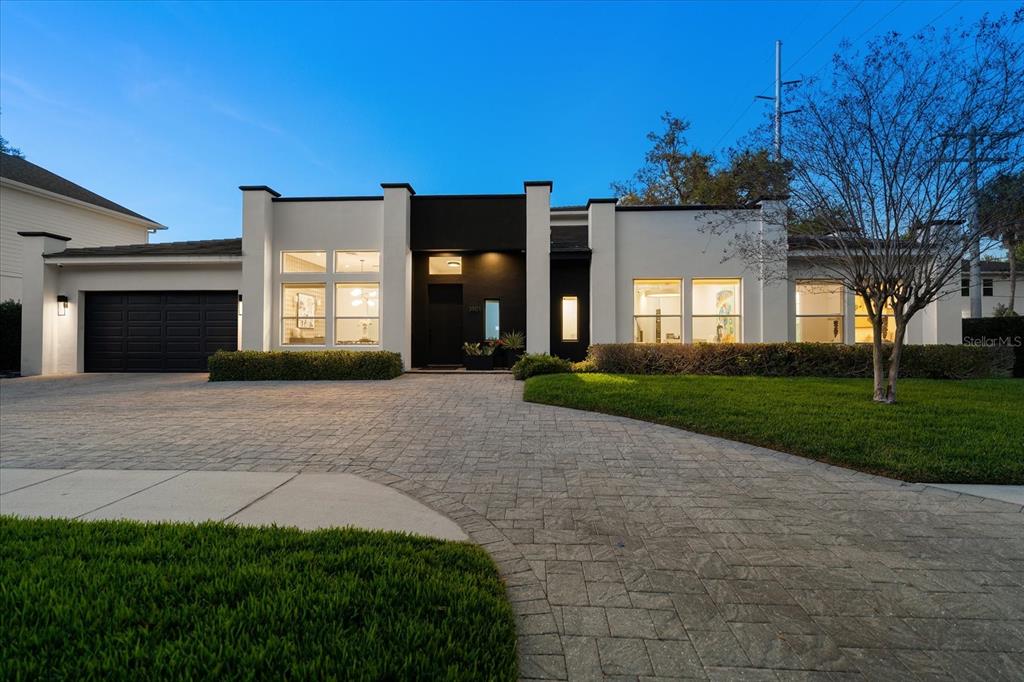 3901 West Granada Street Tampa, FL 33629 - Photo 3 of 45 a front view of a house with a yard and a garage