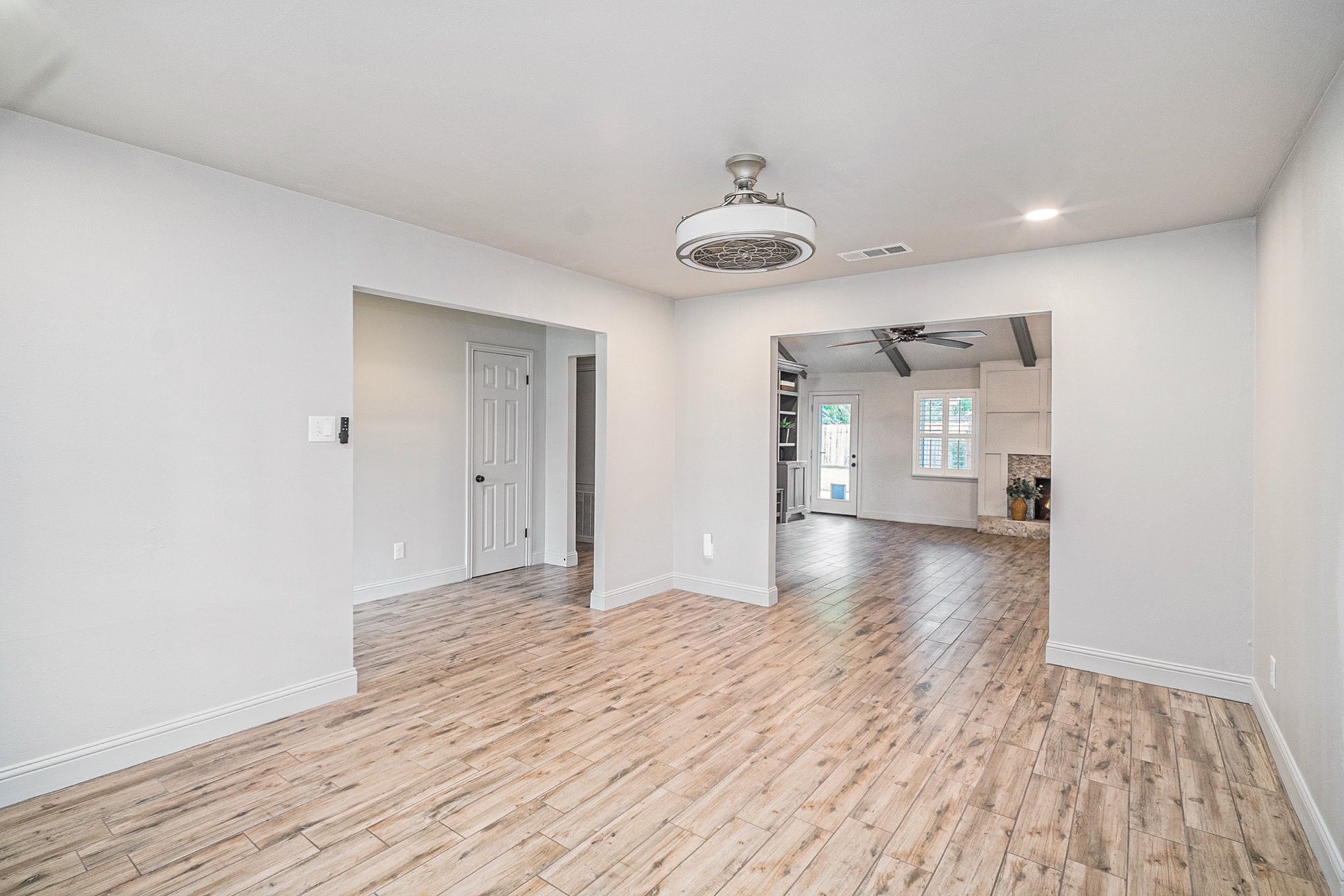 10602 Del Monte Drive Houston, TX 77042 - Photo 11 of 37 a view of a room with wooden floor and a ceiling fan
