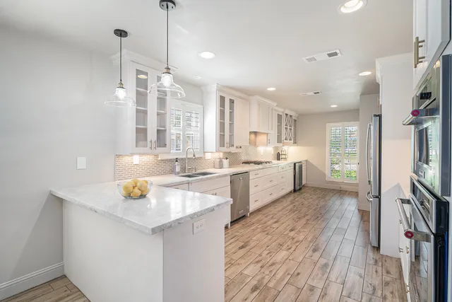 a kitchen with a sink appliances and cabinets