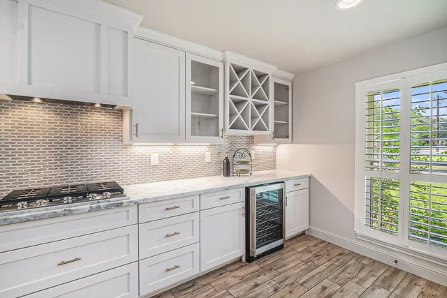 a kitchen with stainless steel appliances granite countertop a stove and a sink