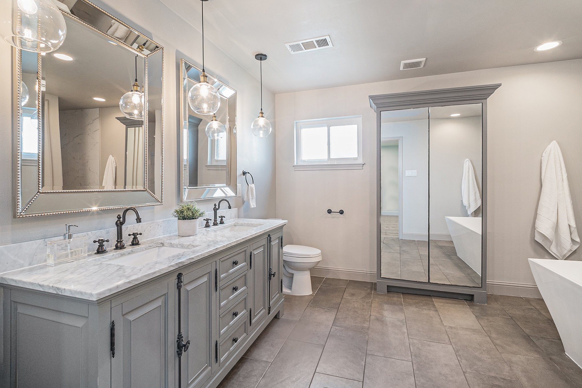 10602 Del Monte Drive Houston, TX 77042 - Photo 20 of 37 a spacious bathroom with a double vanity sink mirror and toilet