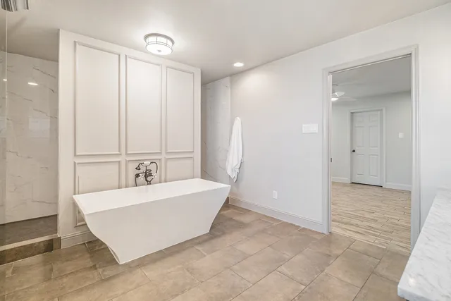 an empty room with white walls and cabinet