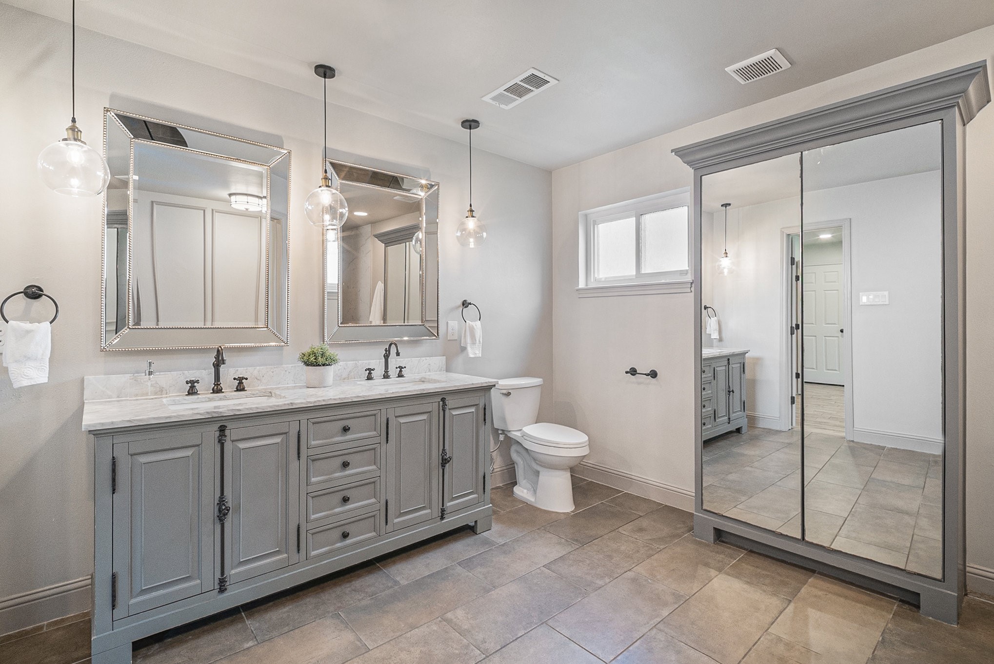 10602 Del Monte Drive Houston, TX 77042 - Photo 23 of 37 a bathroom with a double vanity sink mirror and toilet