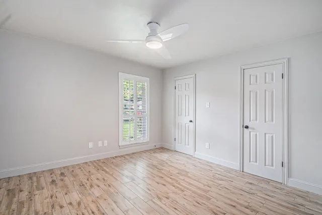 wooden floor in an empty room with a window