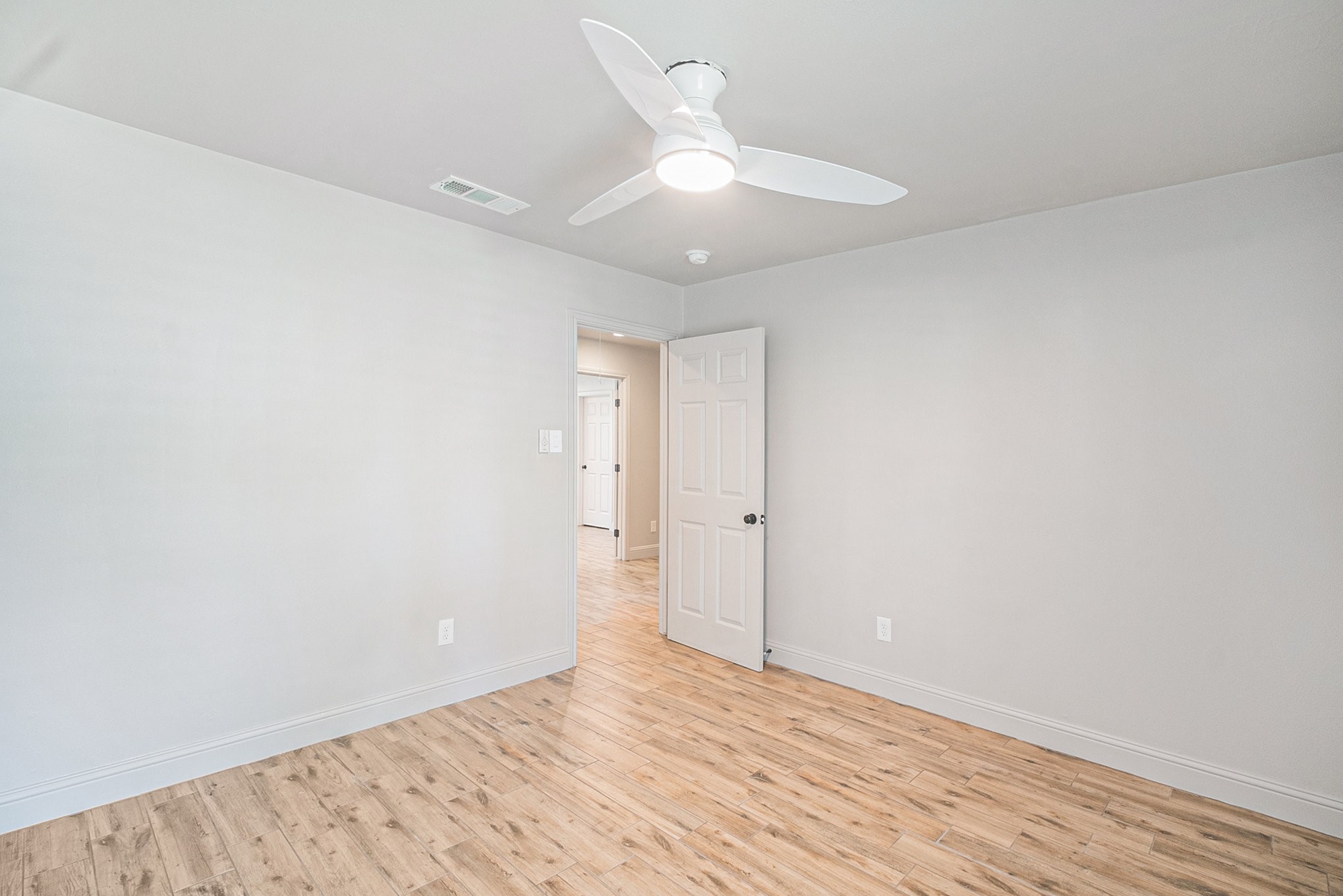 10602 Del Monte Drive Houston, TX 77042 - Photo 25 of 37 a view of an empty room with wooden floor