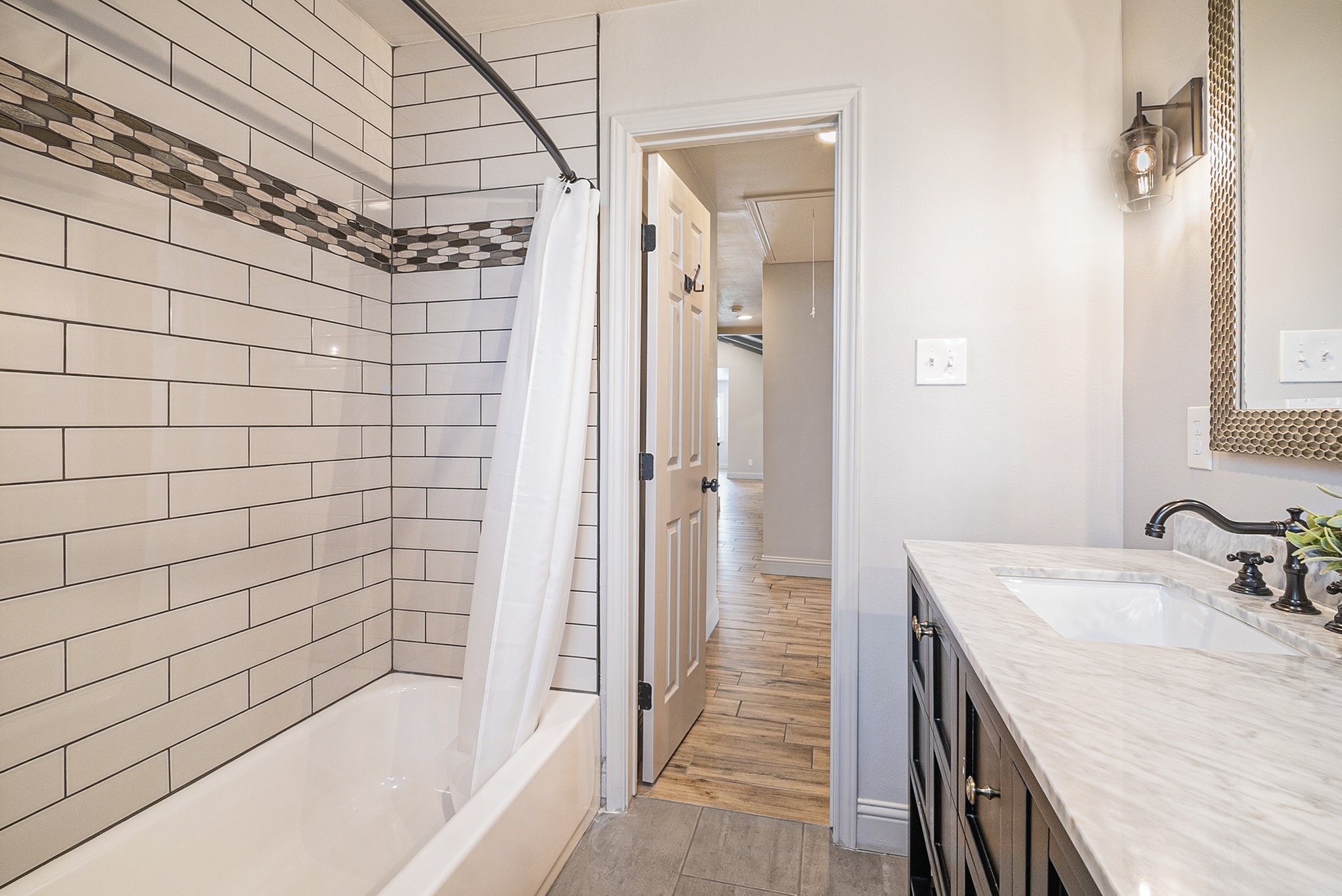 10602 Del Monte Drive Houston, TX 77042 - Photo 32 of 37 a bathroom with a granite countertop sink a toilet and shower