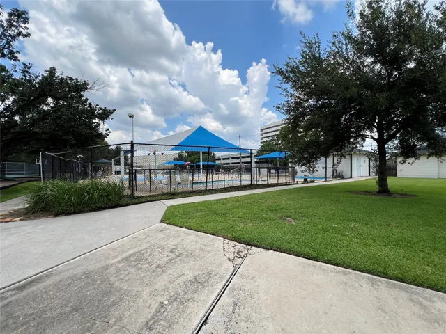 a view of a park with bench and trees