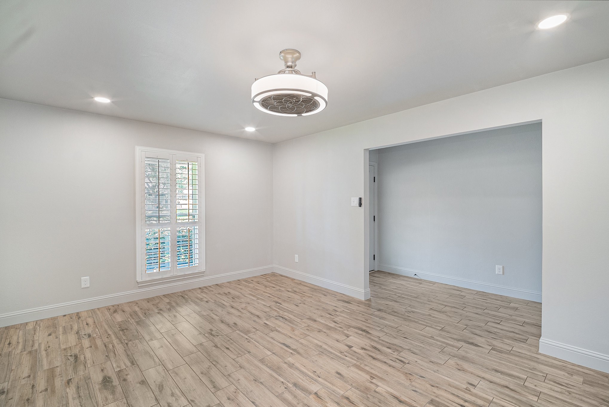 10602 Del Monte Drive Houston, TX 77042 - Photo 9 of 37 wooden floor in an empty room with a window