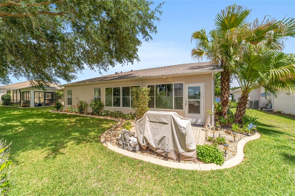 16369 Southwest 14th Avenue Road Ocala, FL 34473 - Photo 44 of 49 a view of house with backyard outdoor seating and barbeque oven