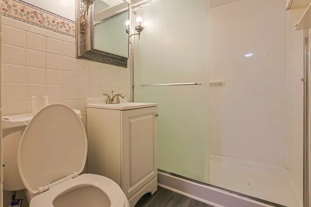 a bathroom with a sink a toilet and a mirror