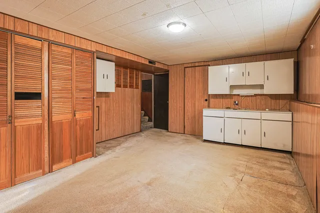a view of a kitchen with a sink and cabinets